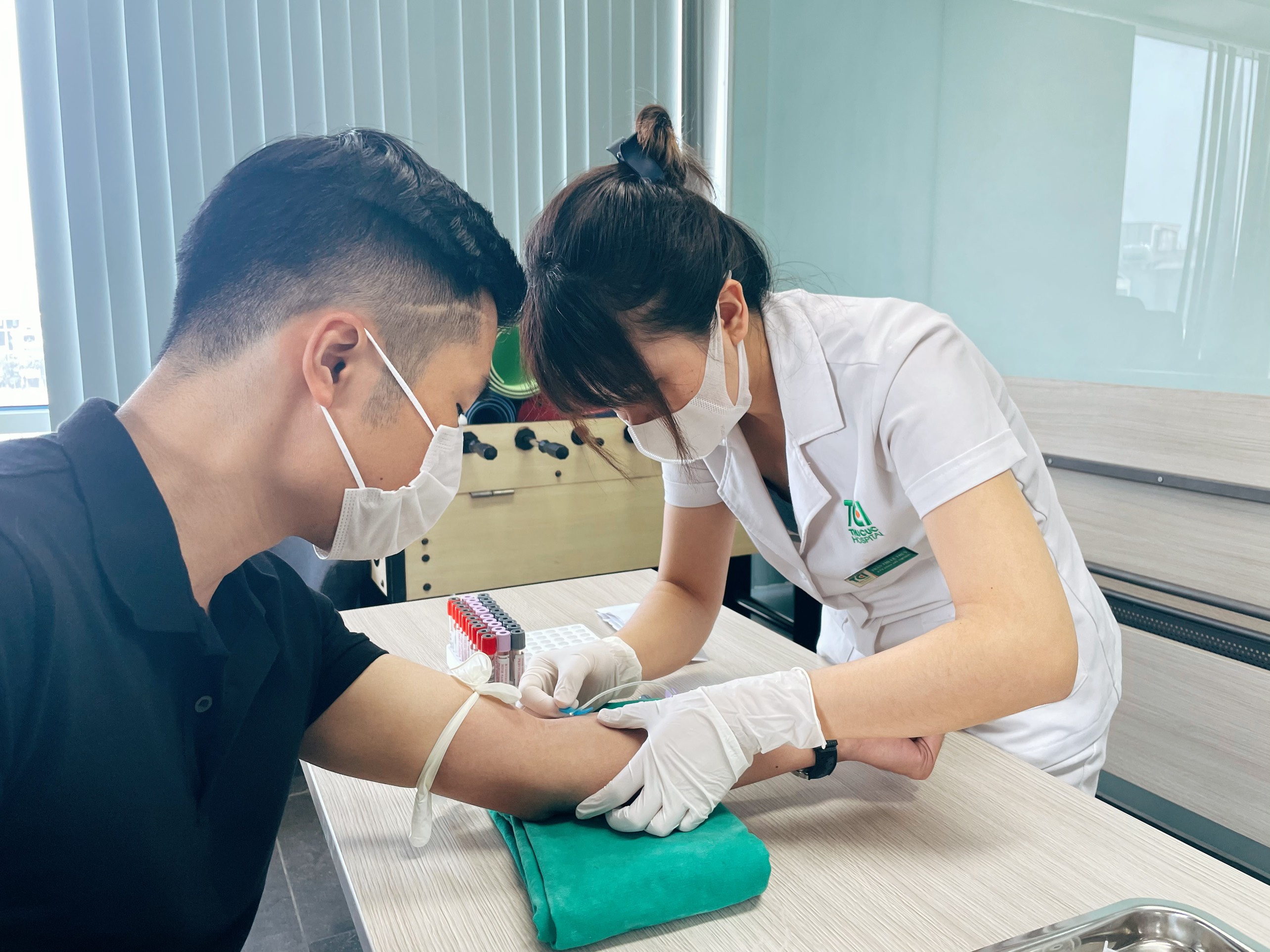 Nurse drawing blood from patient for laboratory blood test procedure