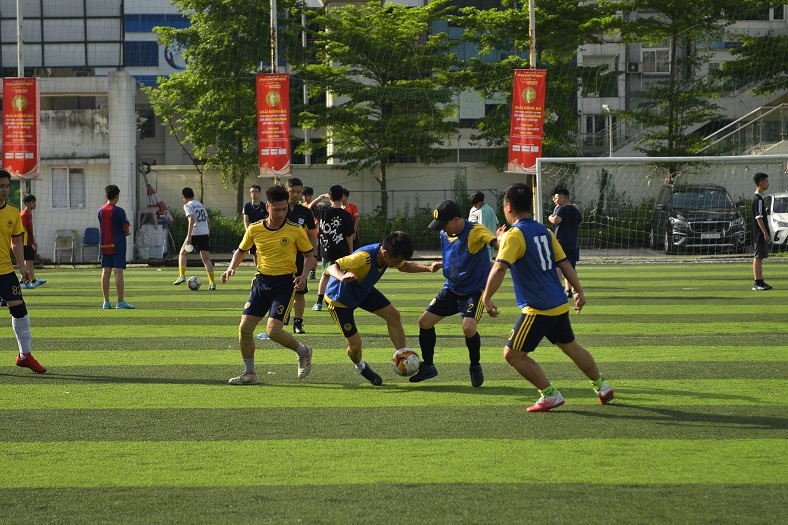 Youth soccer players competing during a team training session on turf field