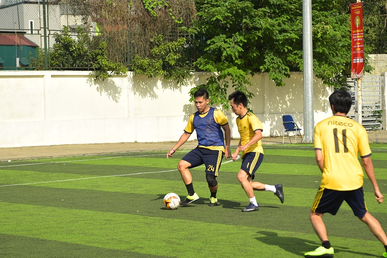 Young men playing soccer on a sunny day with vibrant green turf field