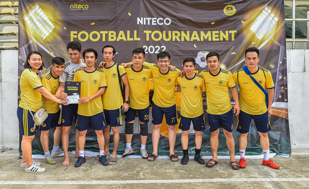 NITECO football tournament 2022 team in yellow jerseys holding award certificate