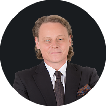 Business professional wearing suit and tie with a confident smile