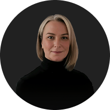 Professional woman with blonde hair wearing a black turtleneck on dark background