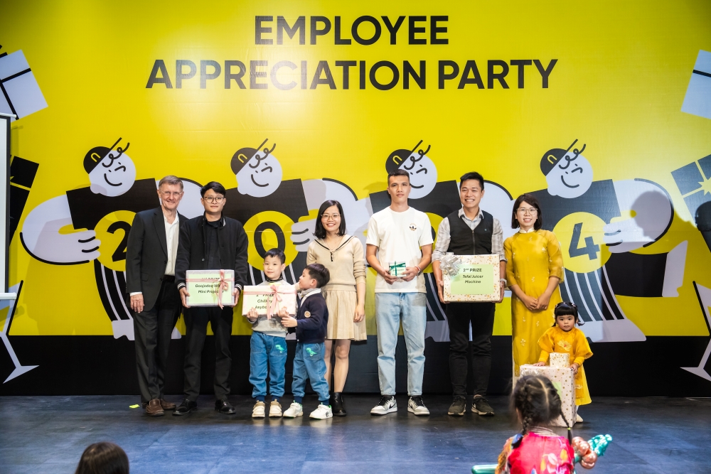 Employee appreciation party with team members and children receiving awards