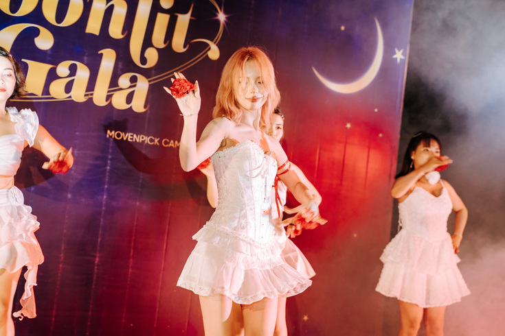 Women performing dance in white dresses at Moonlit Gala event stage