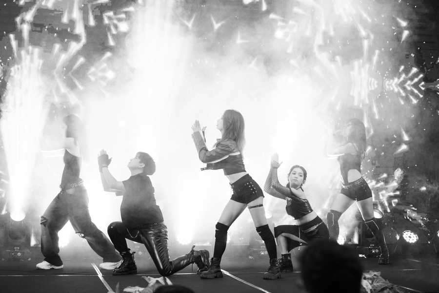 K-pop dance performance with smoky stage and dynamic group choreography
