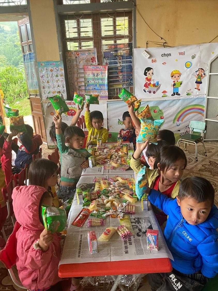 Children enjoying snacks during a social activity in a colorful classroom setting