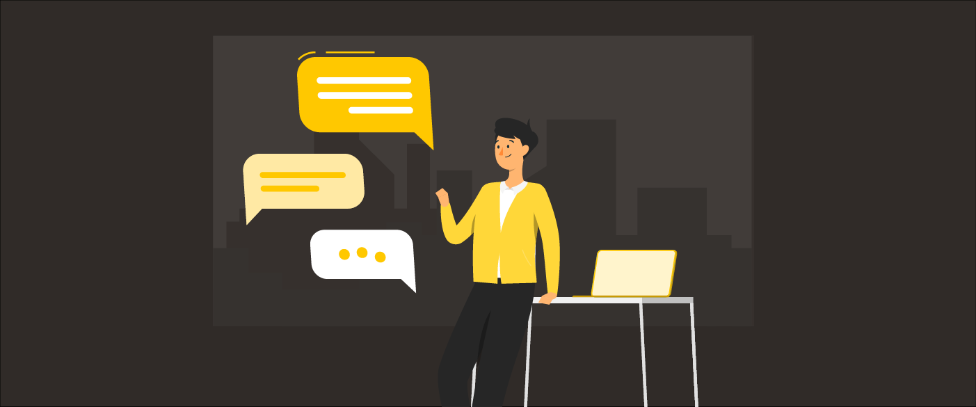 Man in yellow jacket chatting with chatbot messages near laptop on table