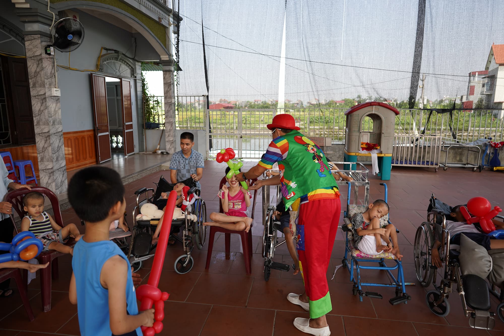 Clown making balloon animals for children