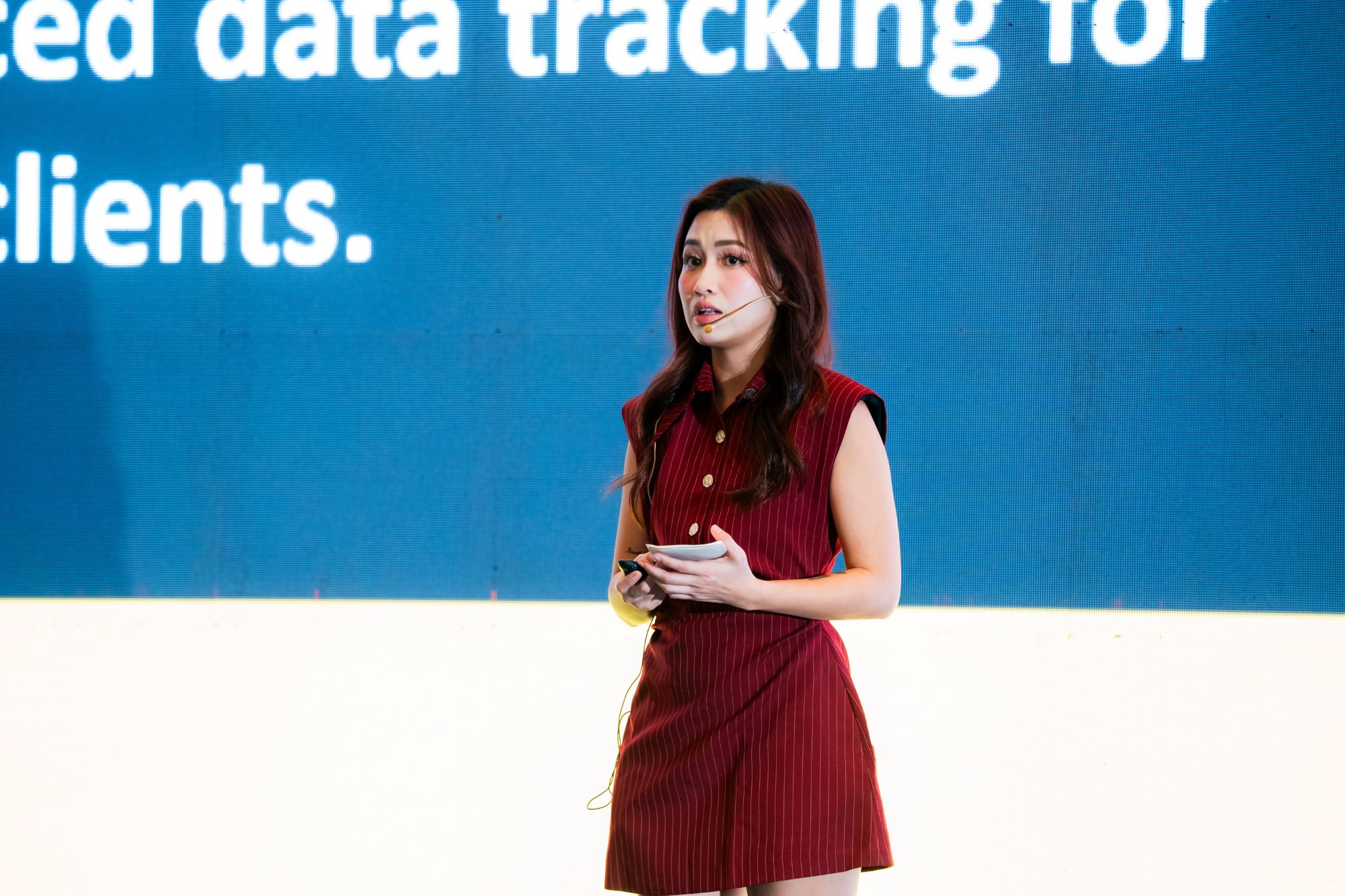 Woman presenting advanced data tracking for clients with headset microphone