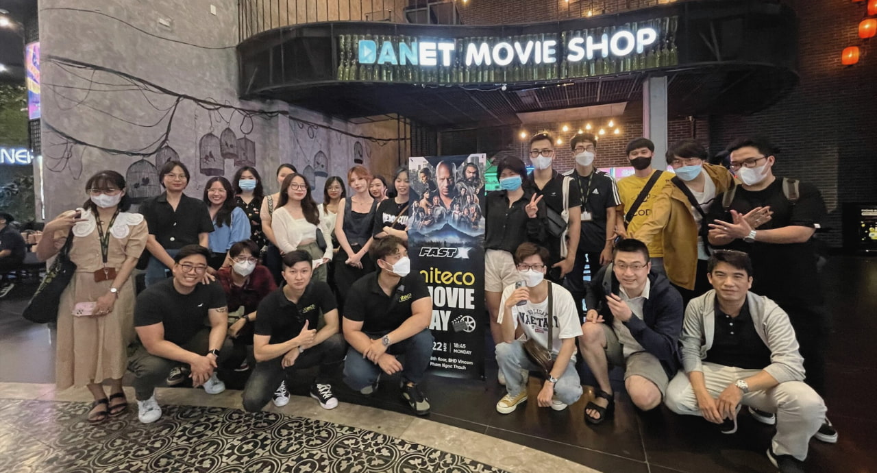 Group of people at Danet Movie Shop for Uniteco Movie Day event with Fast poster