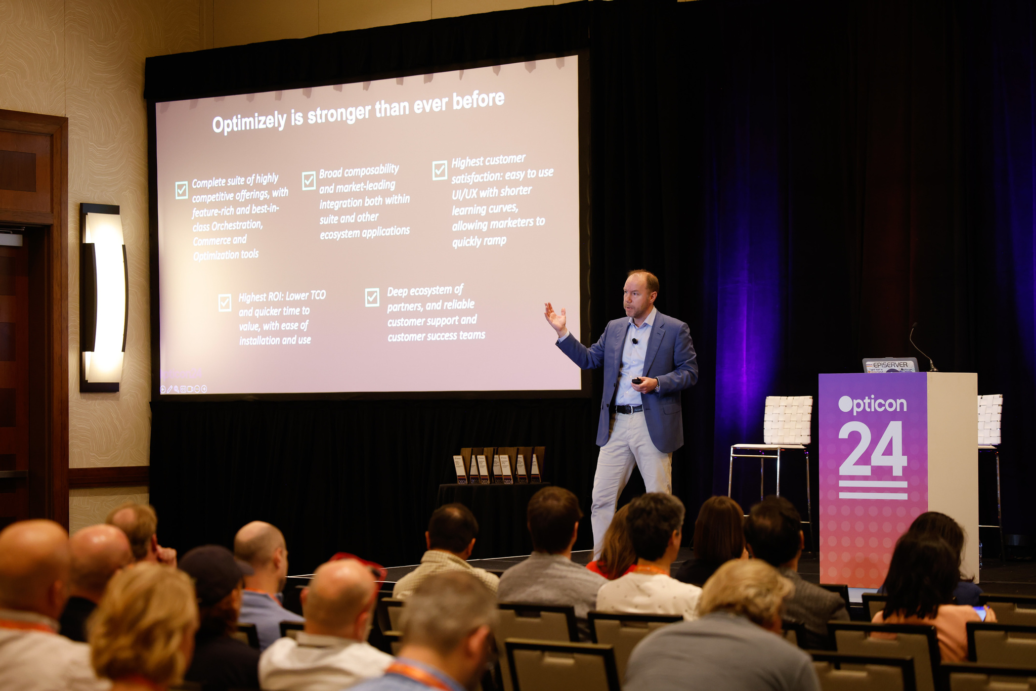 Conference speaker presenting Optimizely features at Opticon 24 event to audience