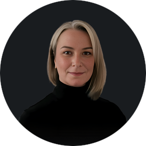 Professional headshot of a confident woman with blonde hair in black turtleneck