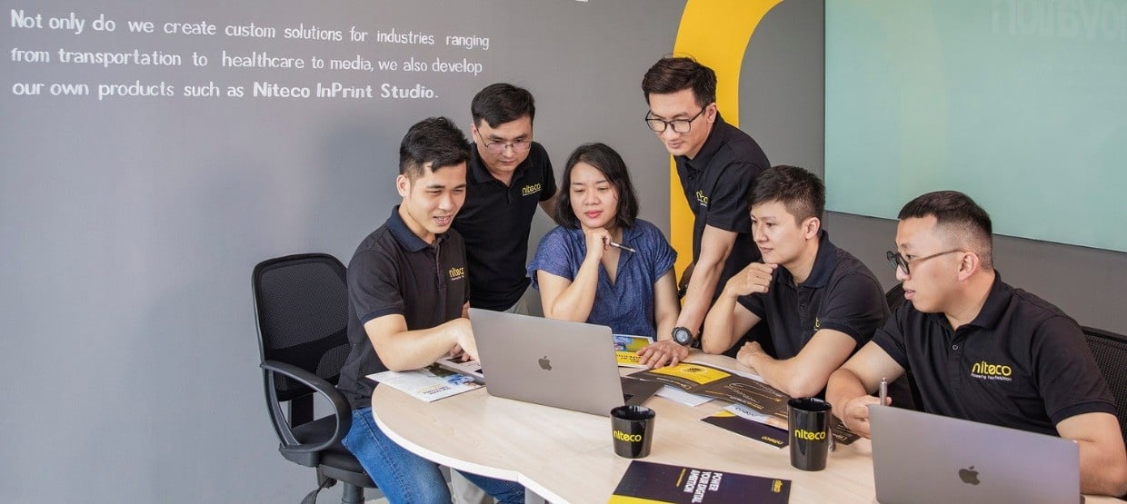Team collaborating on custom software solutions at Niteco InPrint Studio office.