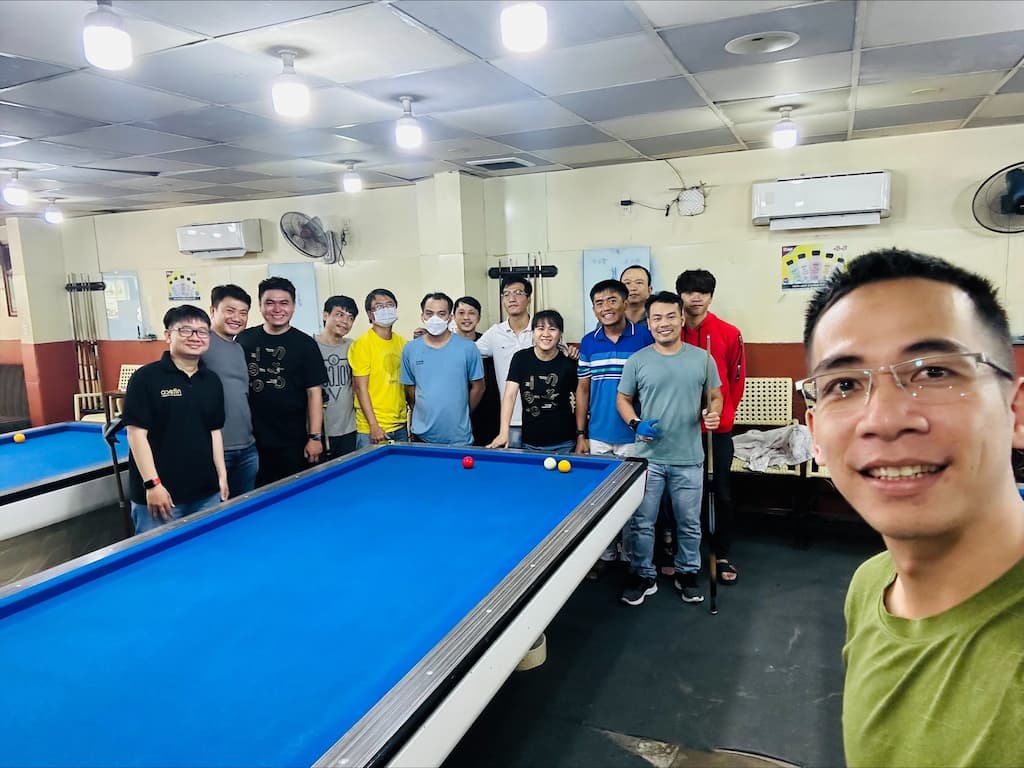 Group of friends enjoying billiards game in indoor pool hall together