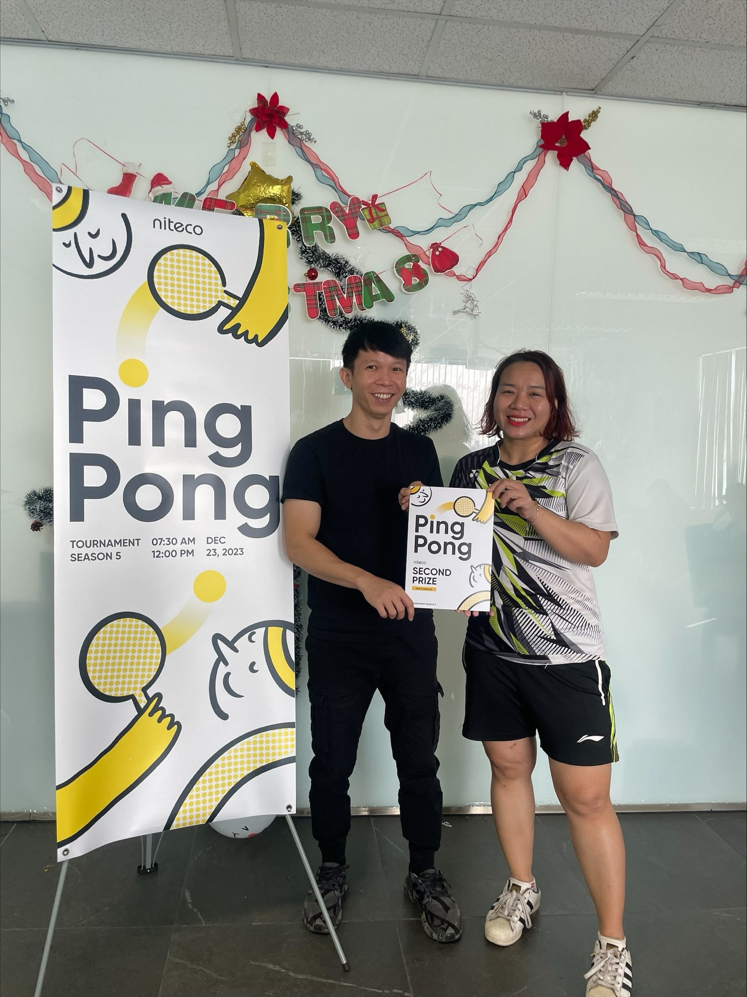 Two smiling players holding second prize certificate at Ping Pong tournament event.