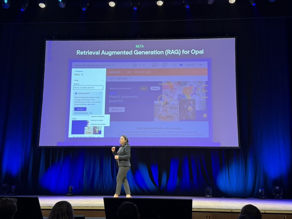 Speaker presenting Retrieval Augmented Generation (RAG) for Opal on stage with a screen.