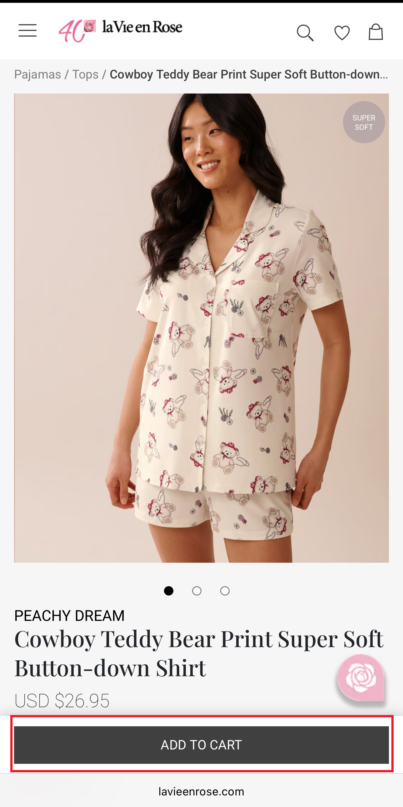 Woman wearing a button-down shirt and shorts with teddy bear print pajamas.