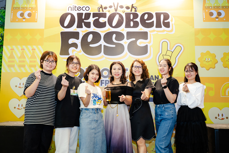 Group of friends celebrating Oktoberfest with drinks and festive smiles