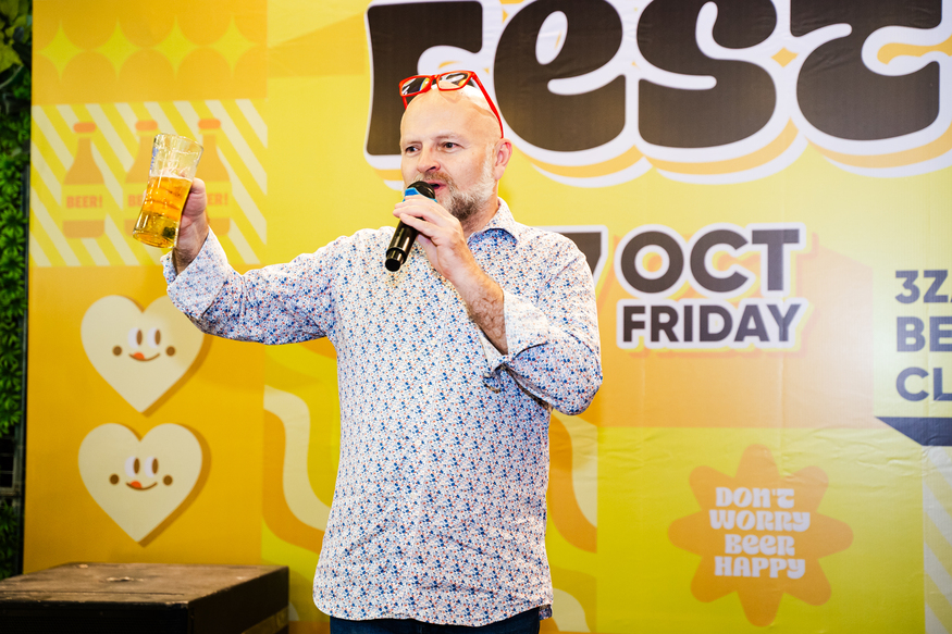 Man making a toast with a beer glass at festival event on 7 Oct Friday