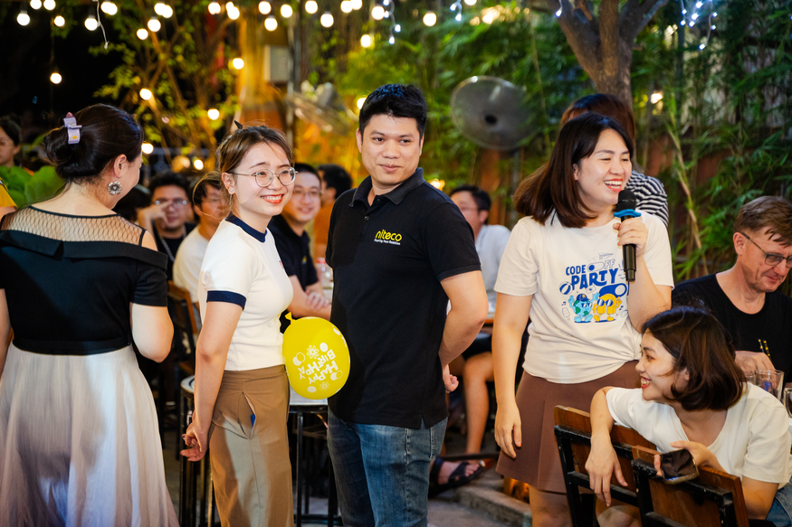 Team celebrates at Niteco code party with balloons and festive lights