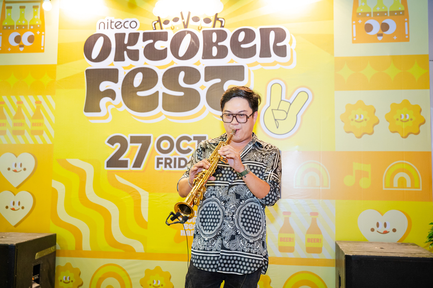 Man playing saxophone at Niteco Oktoberfest event on October 27th