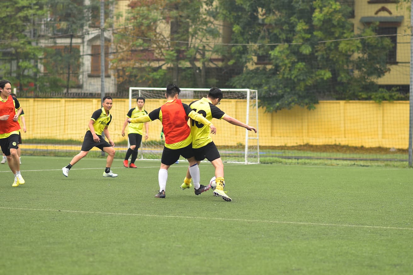 Soccer players competing for the ball during a match on a green field