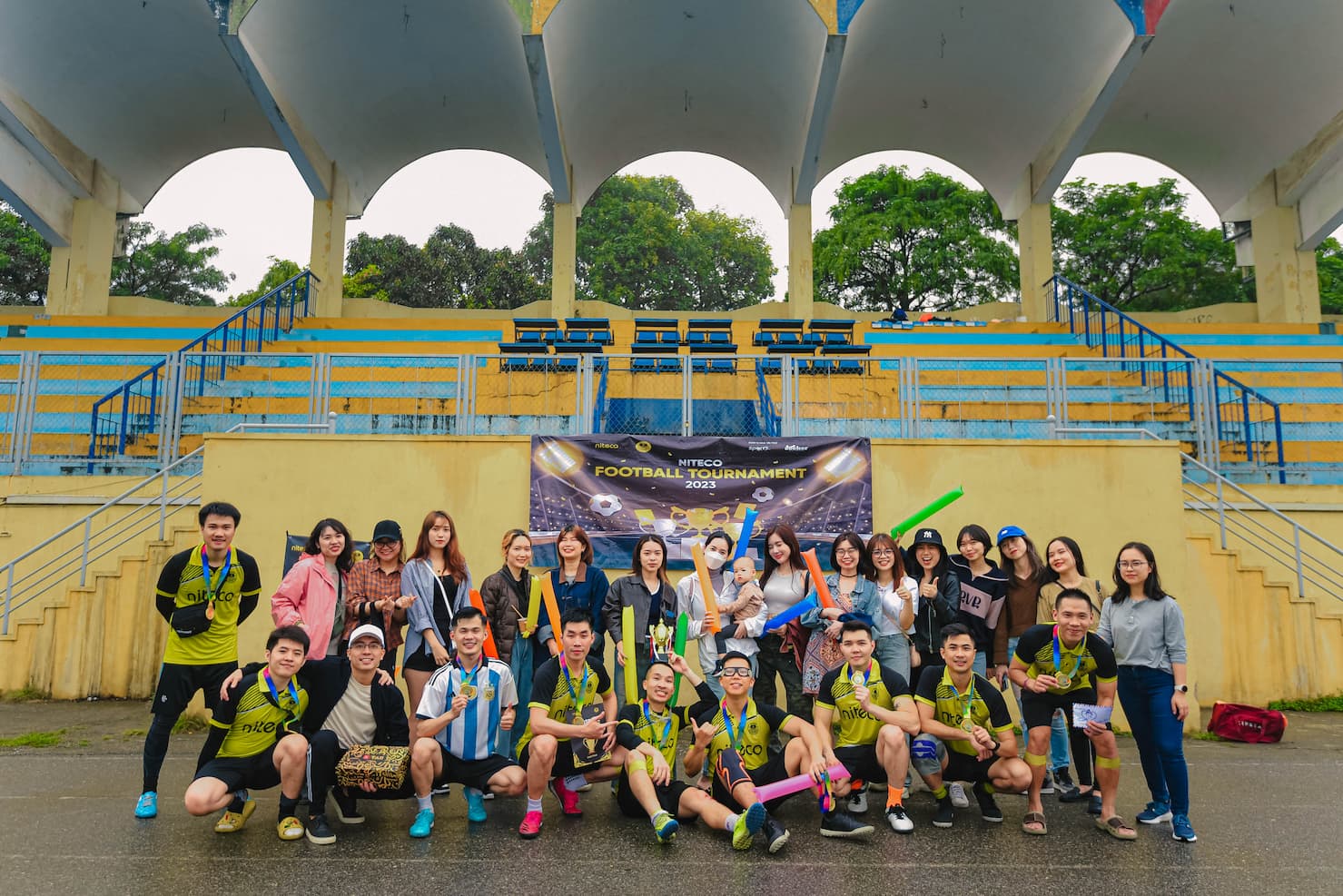 Niteco Football Tournament 2023 team celebrating with medals and fans in stadium