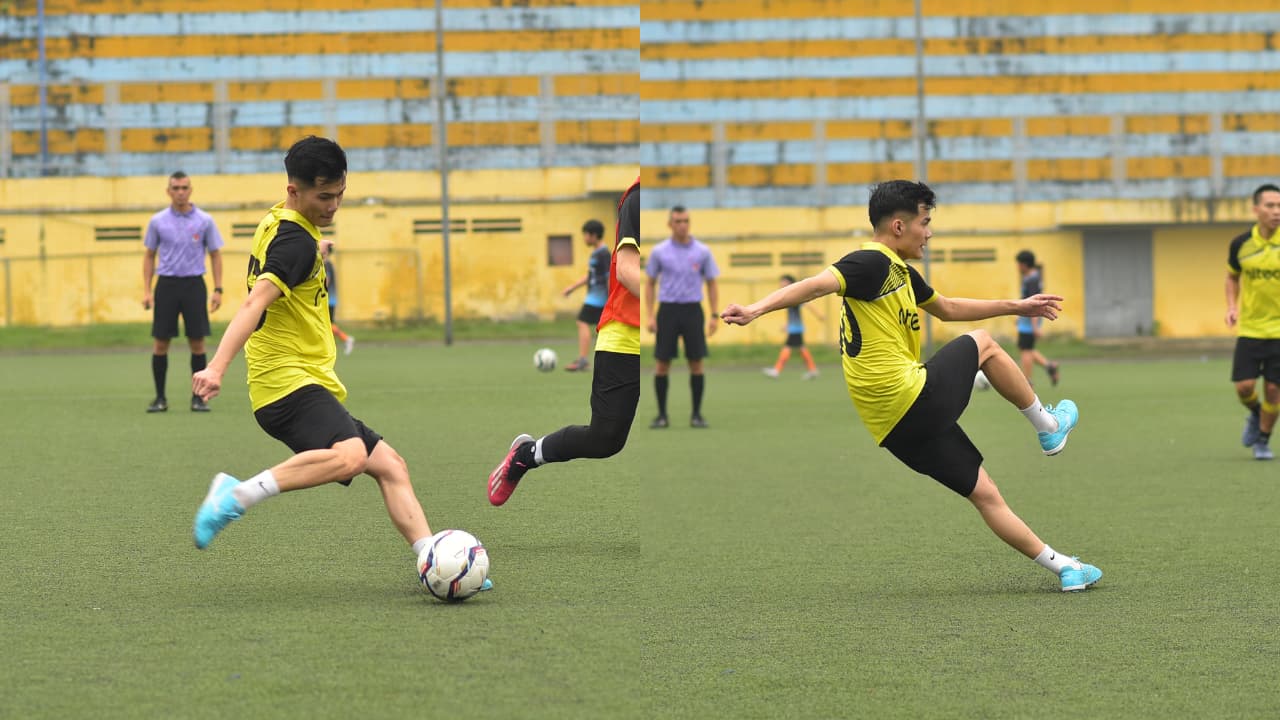 Football players in yellow jerseys actively compete on a green artificial turf field.