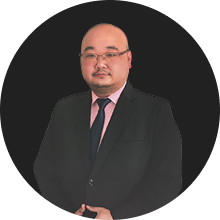 Corporate professional wearing suit and tie standing confidently against black background