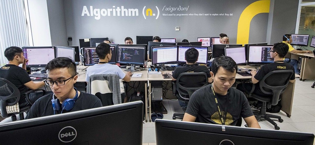 Programmers working on algorithm development in a modern office setting