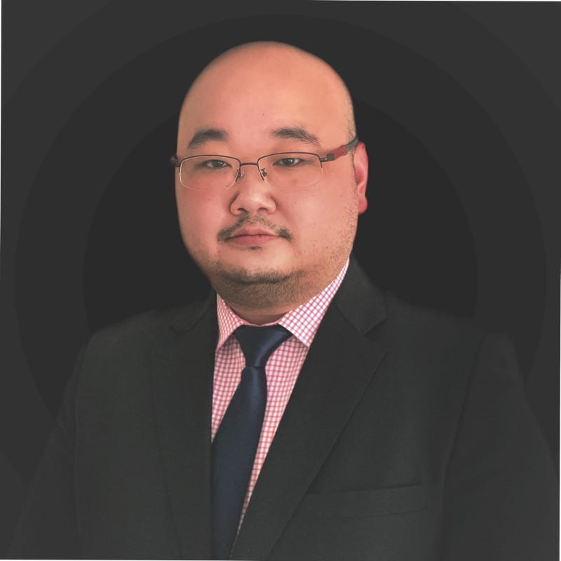 Professional portrait of a businessman wearing glasses and a suit with tie