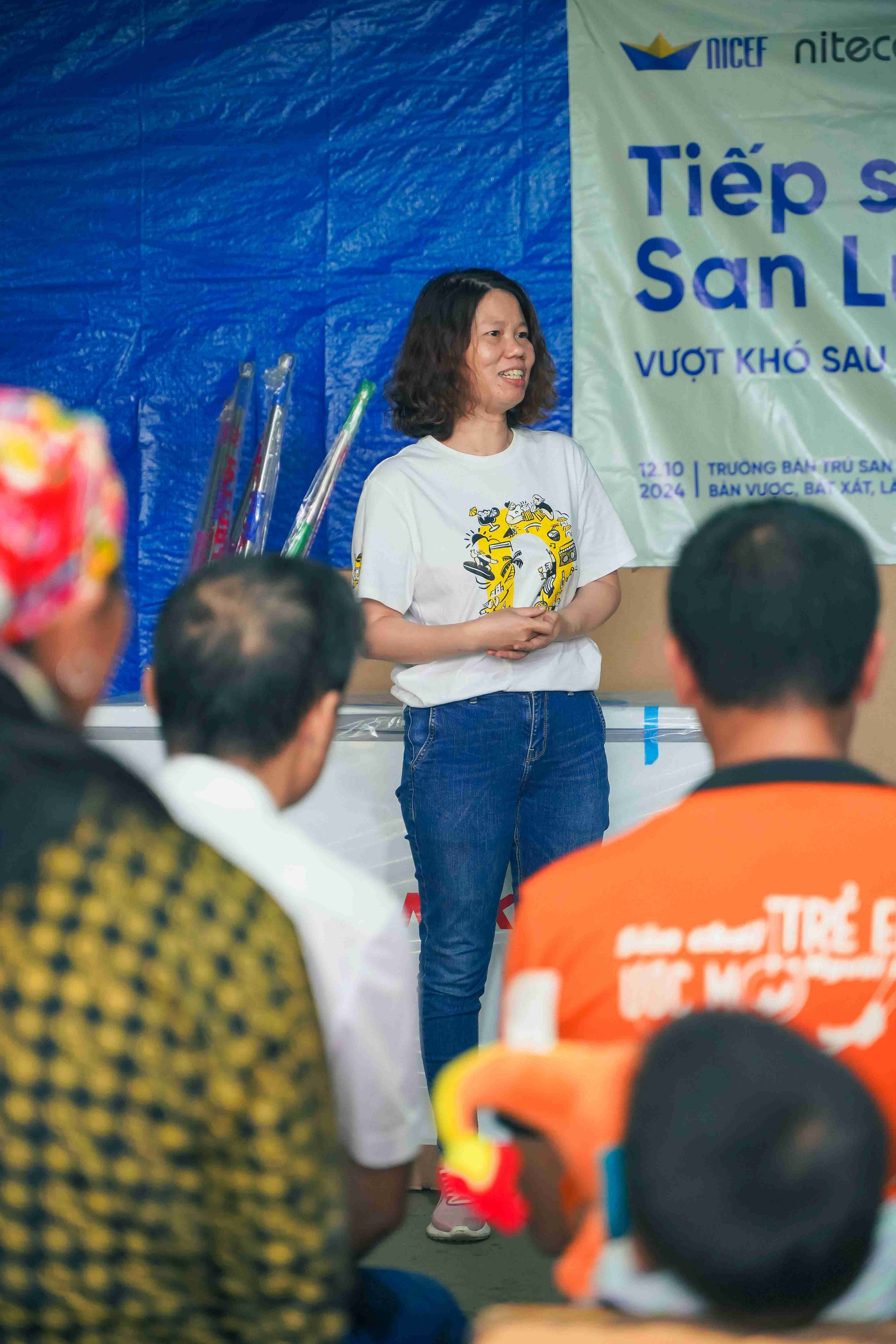 Woman leading community meeting on San Lu public support and recovery