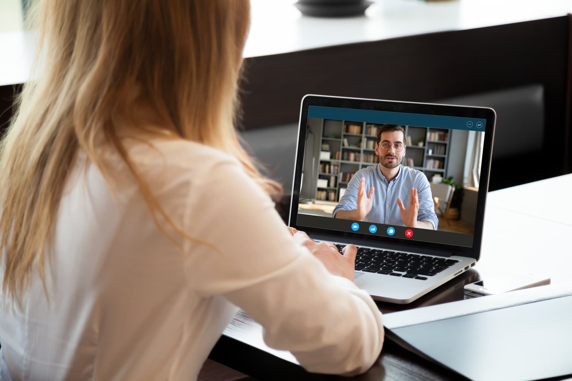 Remote employee conducting video conference call with male coworker