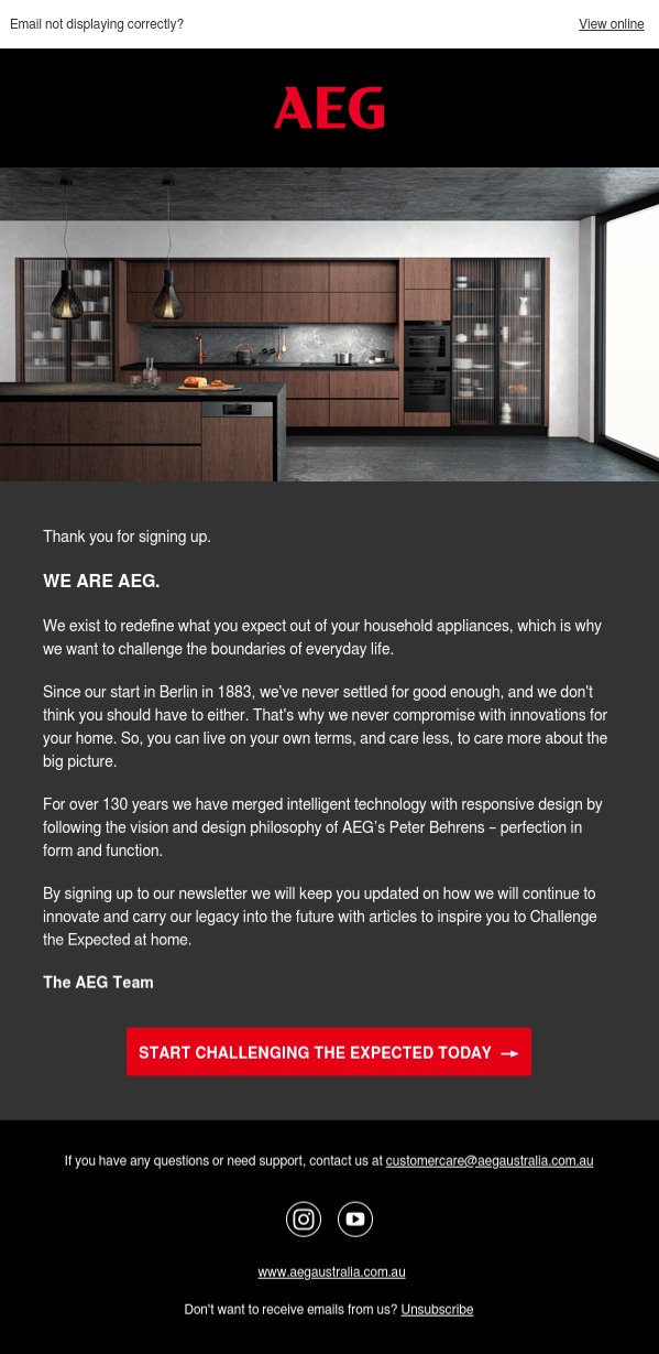 Modern kitchen with AEG appliances featuring sleek wood and black design