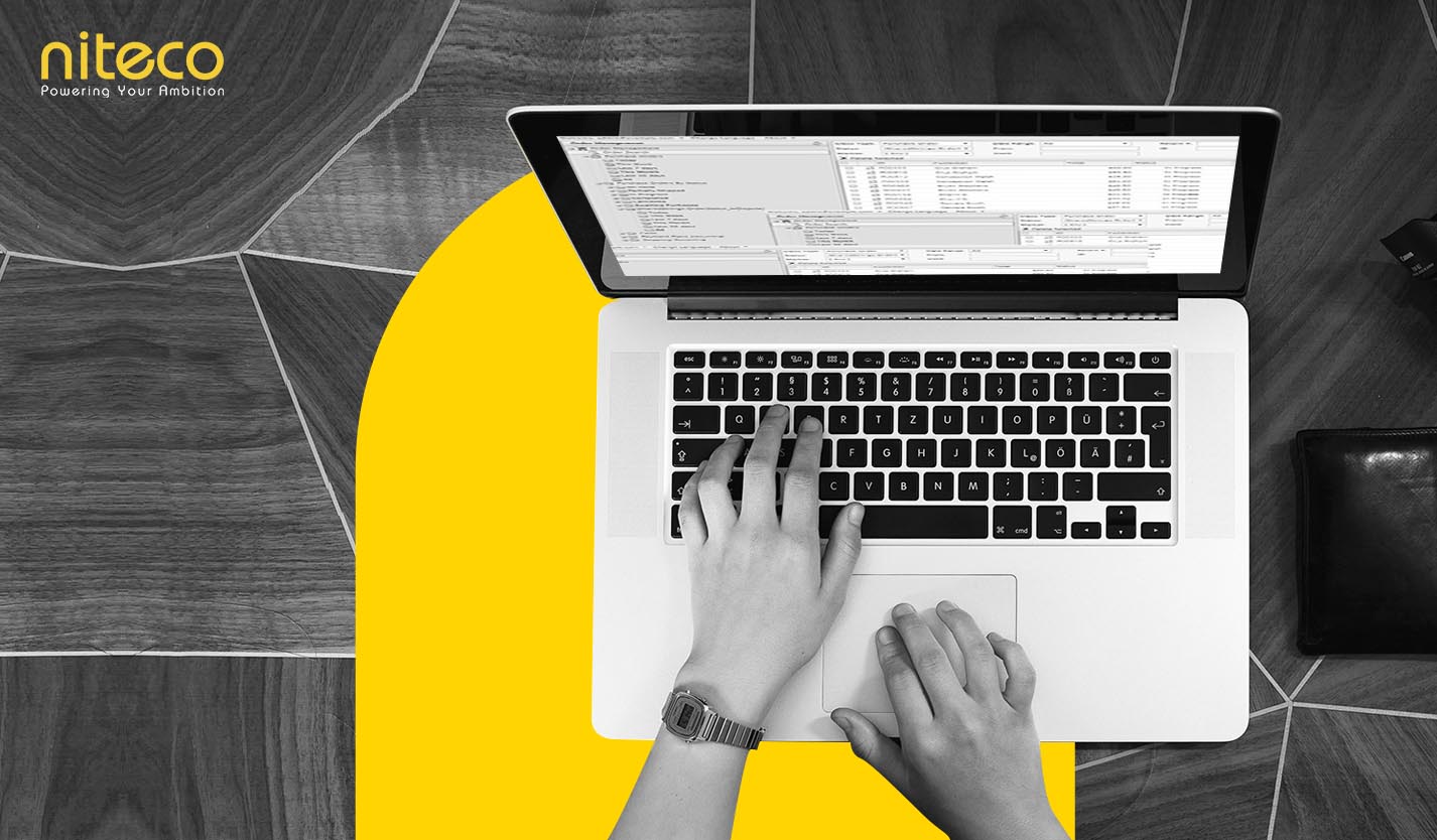 Niteco software developer coding on laptop with project management tools displayed