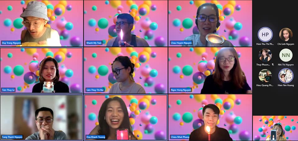 Virtual team celebrating with candles during an online meeting with colorful 3D bubbles background