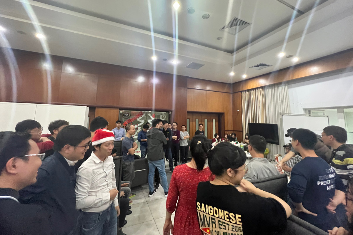 Office Christmas party with Saigonese team celebrating and socializing indoors