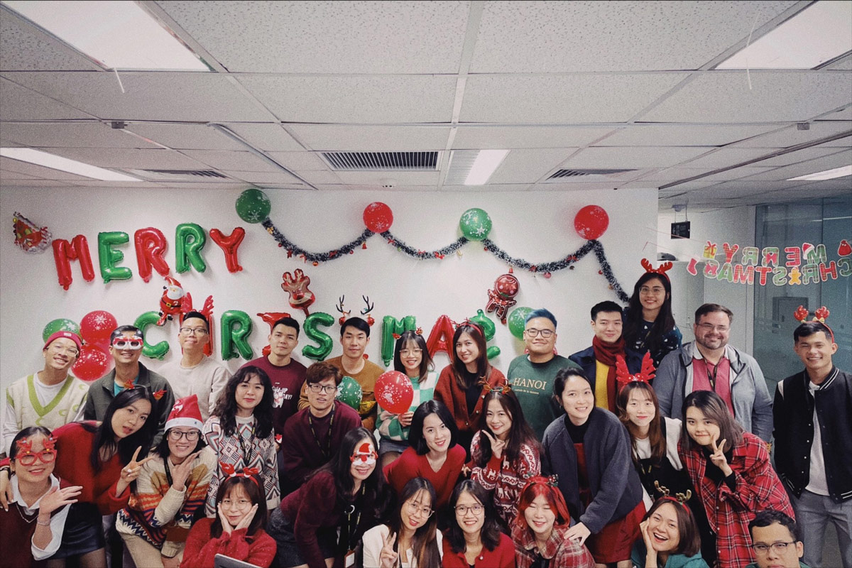 Office team celebrating Merry Christmas with festive decorations and costumes