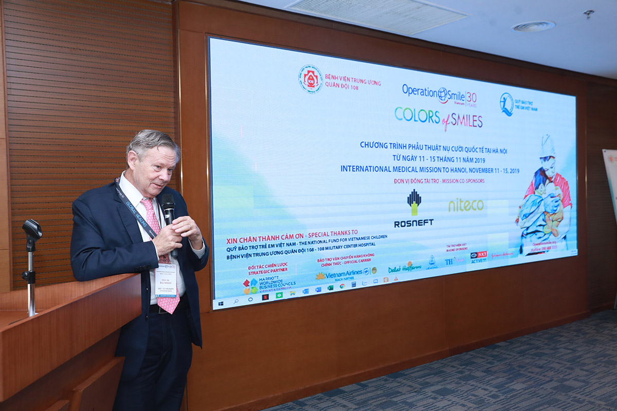 Man speaking at Operation Smile international medical mission presentation in Hanoi