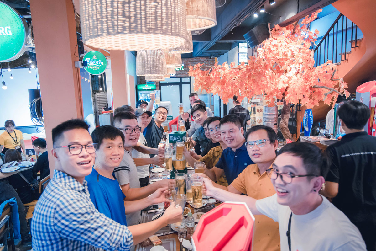 Team celebration at restaurant with drinks and festive autumn decor
