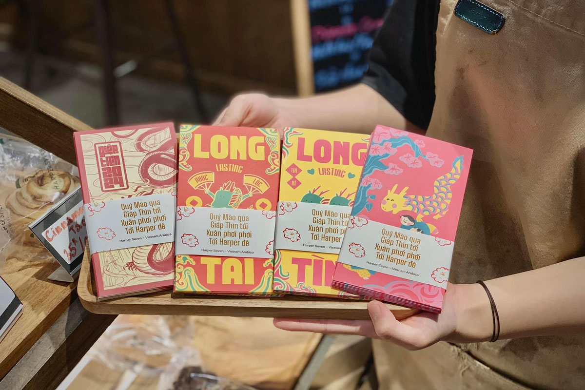 Vietnamese lunar new year red envelopes with colorful symbolic designs on a tray