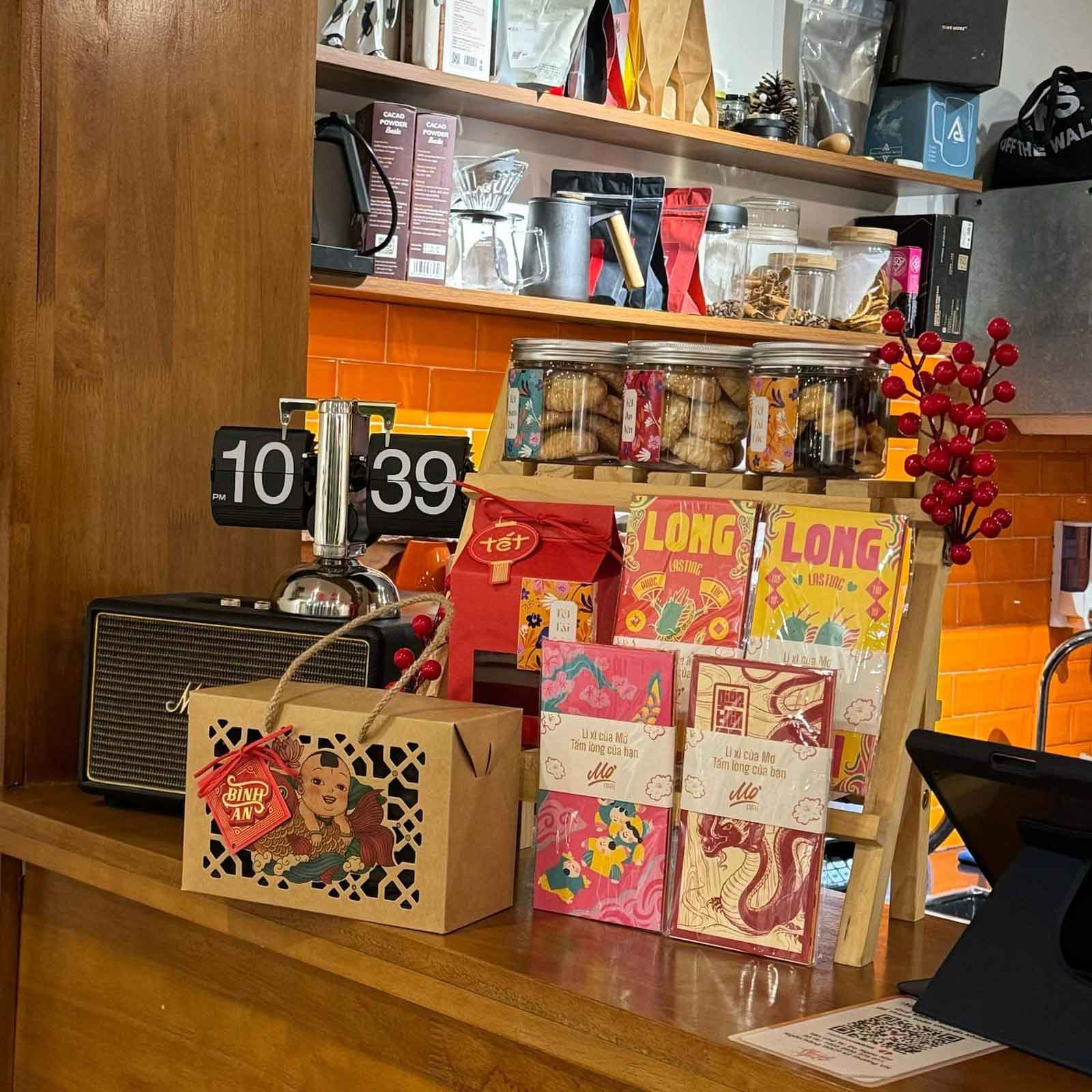 Vietnamese Tet gifts and snacks displayed on a wooden counter with orange tiles